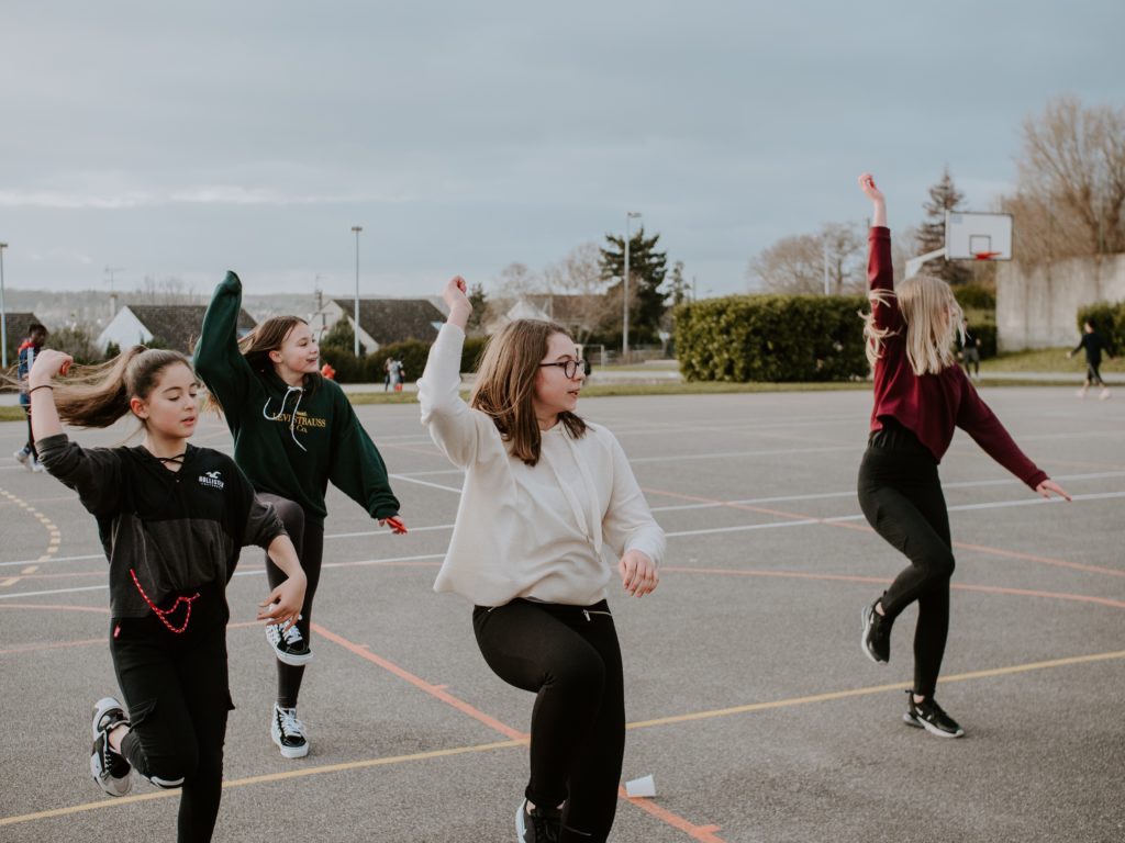 Four teenagers outside exercising.